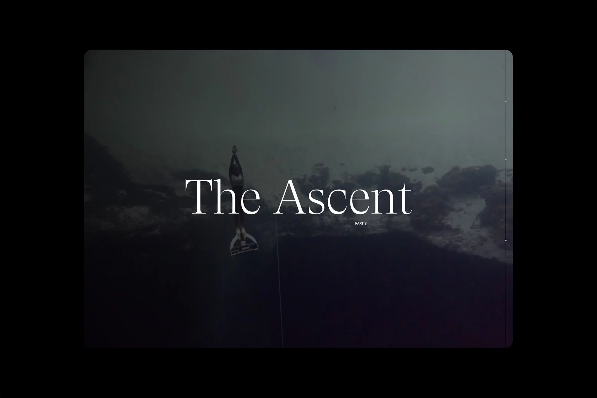 Underwater scene of a freediver ascending in dark water, wearing fins, with visible text overlay 'The Ascent'.