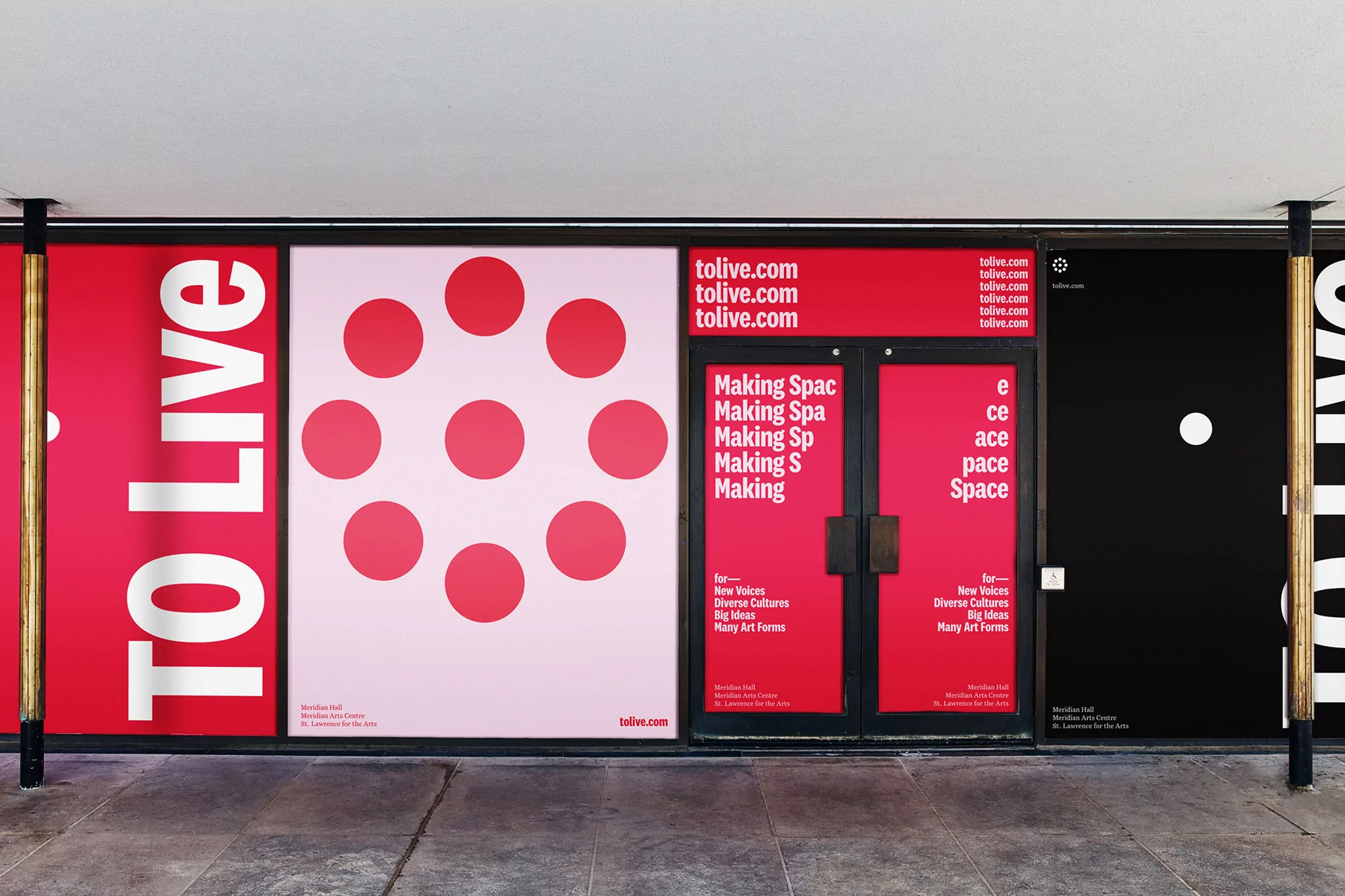 Building facade with 'TO Live' posters in red, pink, and black, featuring geometric designs and text, promoting cultural events.