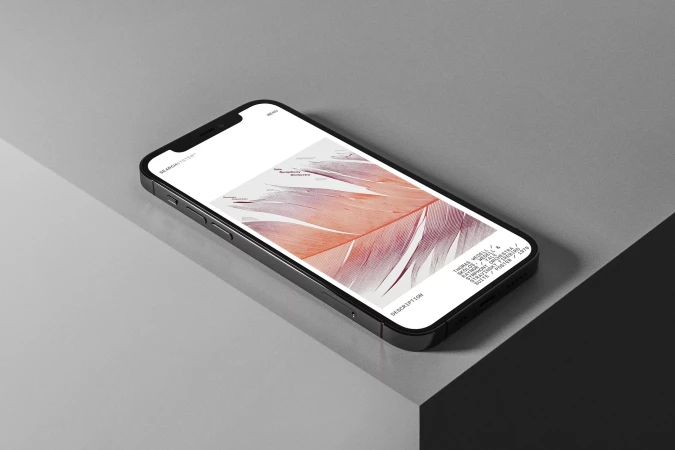 Black smartphone displays linear abstract art on a gray surface, set against a contrasting geometric backdrop. Close-up shot.