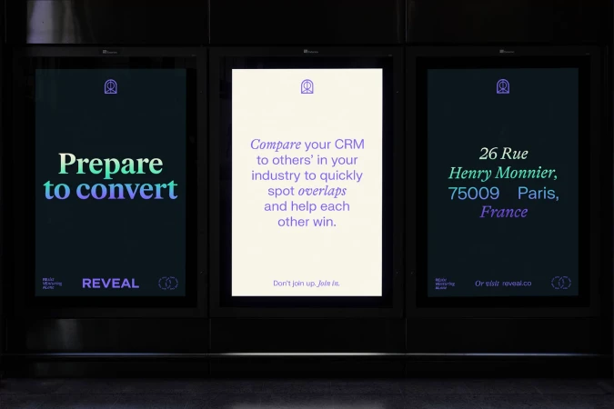 Three digital billboards in a row advertise Reveal, a service to 'compare your CRM to others' in your industry' with Paris address.