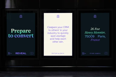 Three vertical digital billboard screens displaying typographic branding for Olami featuring Reveal copy