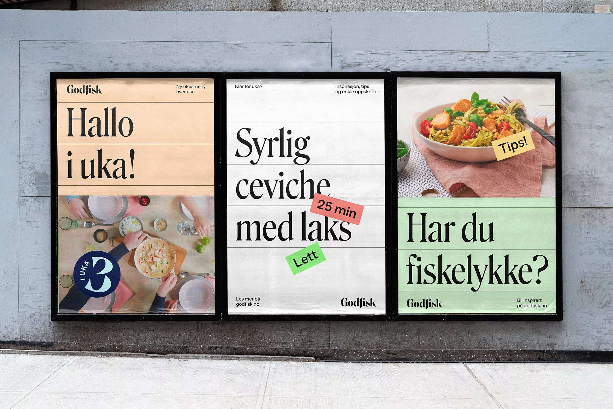 Eye-level shot of three food advertising posters against a gray wall, featuring dishes and promotional text for Godfisk, a Norwegian seafood brand.