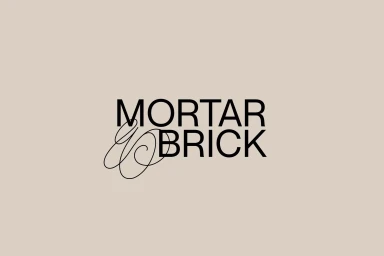 Minimalist brand identity logo for Mortar and Brick featuring bold sans-serif text against a solid beige background.