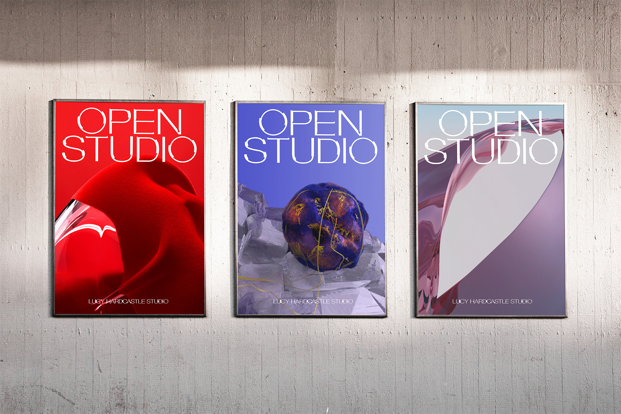 Three posters displaying abstract art with the words 'Open Studio' are evenly spaced on a light grey concrete wall, indoors.