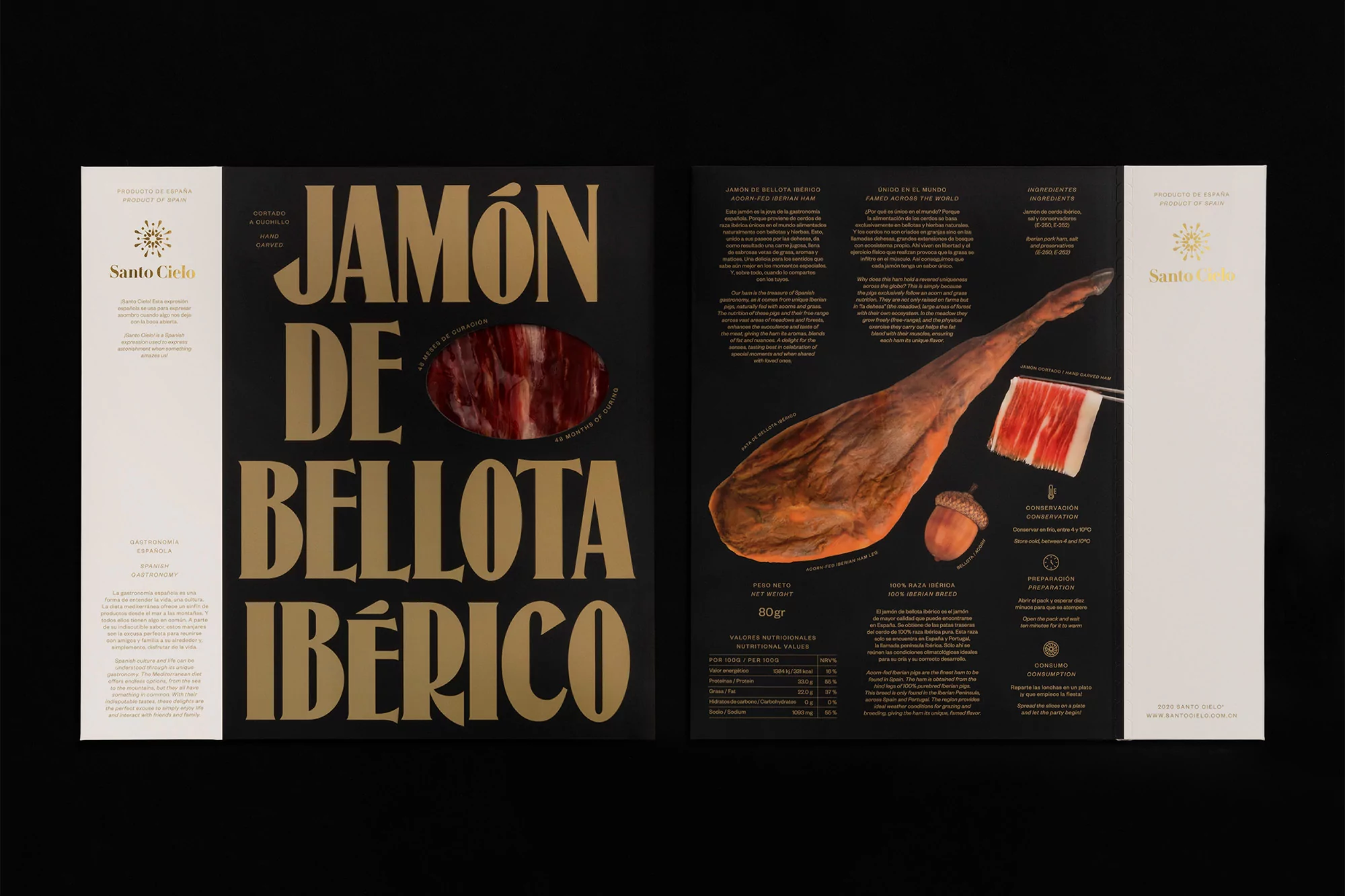 Studio shot of premium Iberian ham packaging: black with gold lettering, acorn illustration, and ham slice window display.