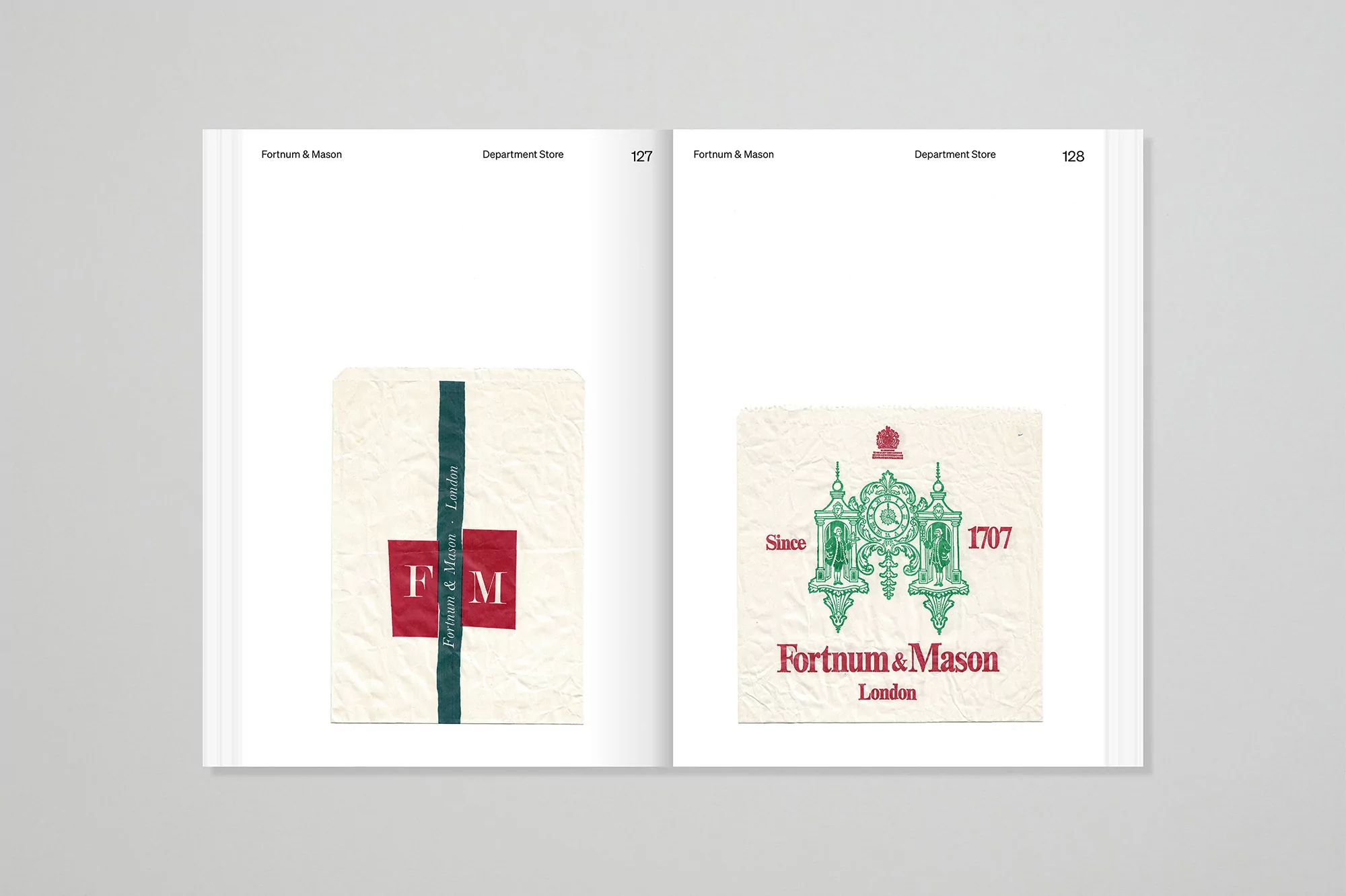 Open book spread featuring Fortnum & Mason graphics on white paper, including logos and brand design elements on each page.