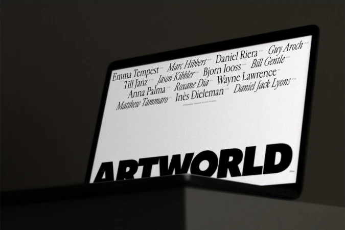 Laptop screen displaying 'ARTWORLD' and a list of names in a dark, indoor setting. The display is the focal point, with minimalist aesthetics.