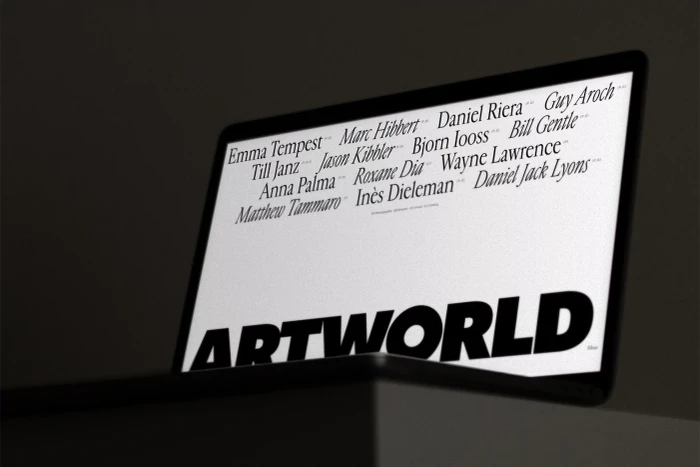 Laptop displaying a white screen with typography and the Artworld brand name against a dark background