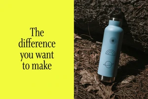 Light blue water bottle resting on pine needles next to a vibrant yellow panel with black typography