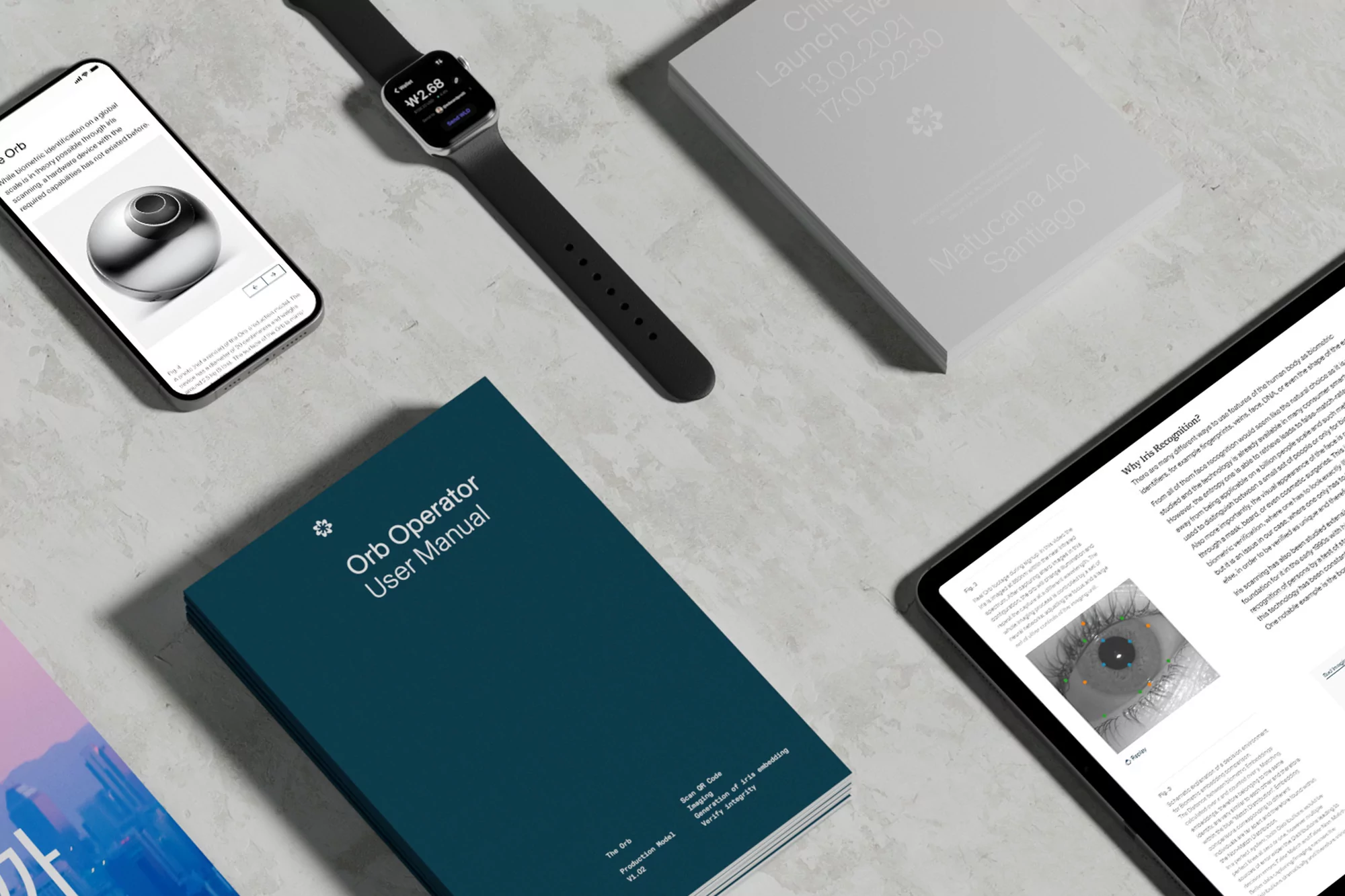 Overhead shot showcases a smart watch, mobile phone, tablet, user manual, and book on a textured grey surface. Technology display.