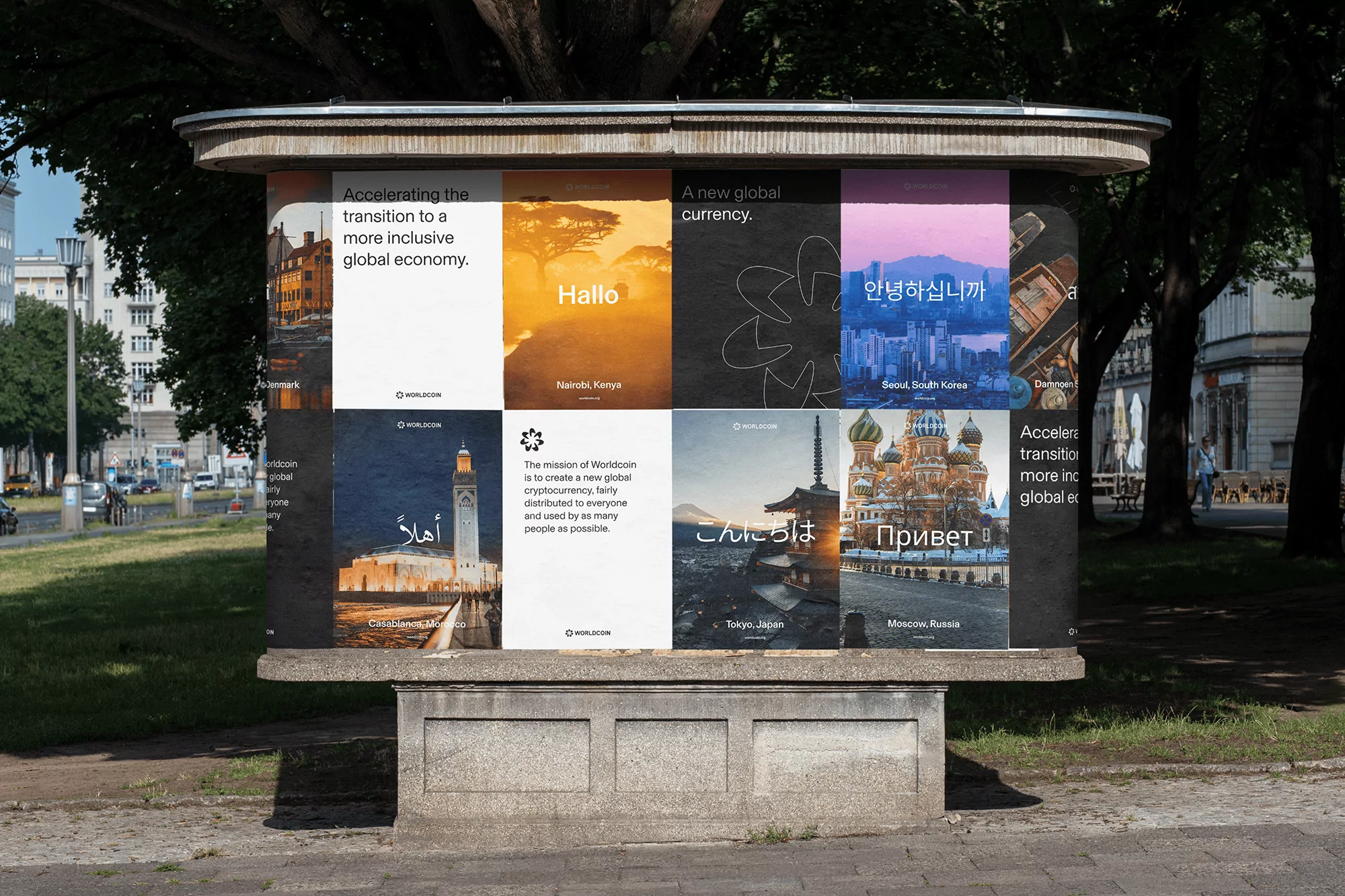 Outdoor advertising billboard displaying the Worldcoin logo and slogans in multiple languages against cityscape and nature backgrounds. Public advertising.