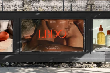 Outdoor advertising billboard featuring LBDO branding and intimate imagery mounted on a dark exterior wall