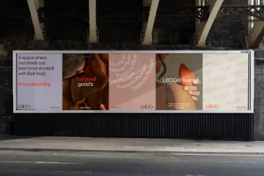 Large outdoor billboard display showcasing the LBDO brand identity campaign mounted beneath an industrial bridge.