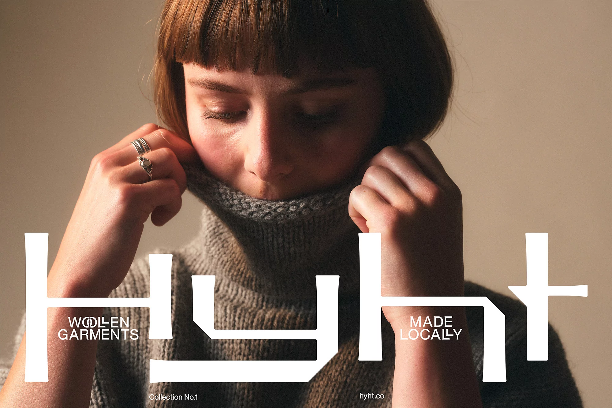 Close-up of a woman wearing a gray turtleneck sweater, shot in a photo studio with soft lighting. Garment and fashion concept.