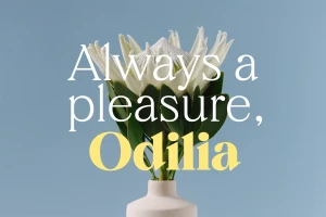 White protea flower in a cream ceramic vase against a blue background with overlaid typography reading Always a pleasure, Odilia