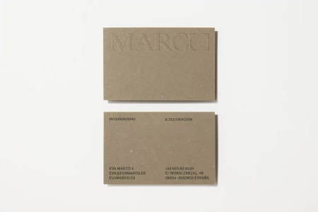 Two rectangular brown textured business cards displayed flat on a clean white surface with minimal shadows
