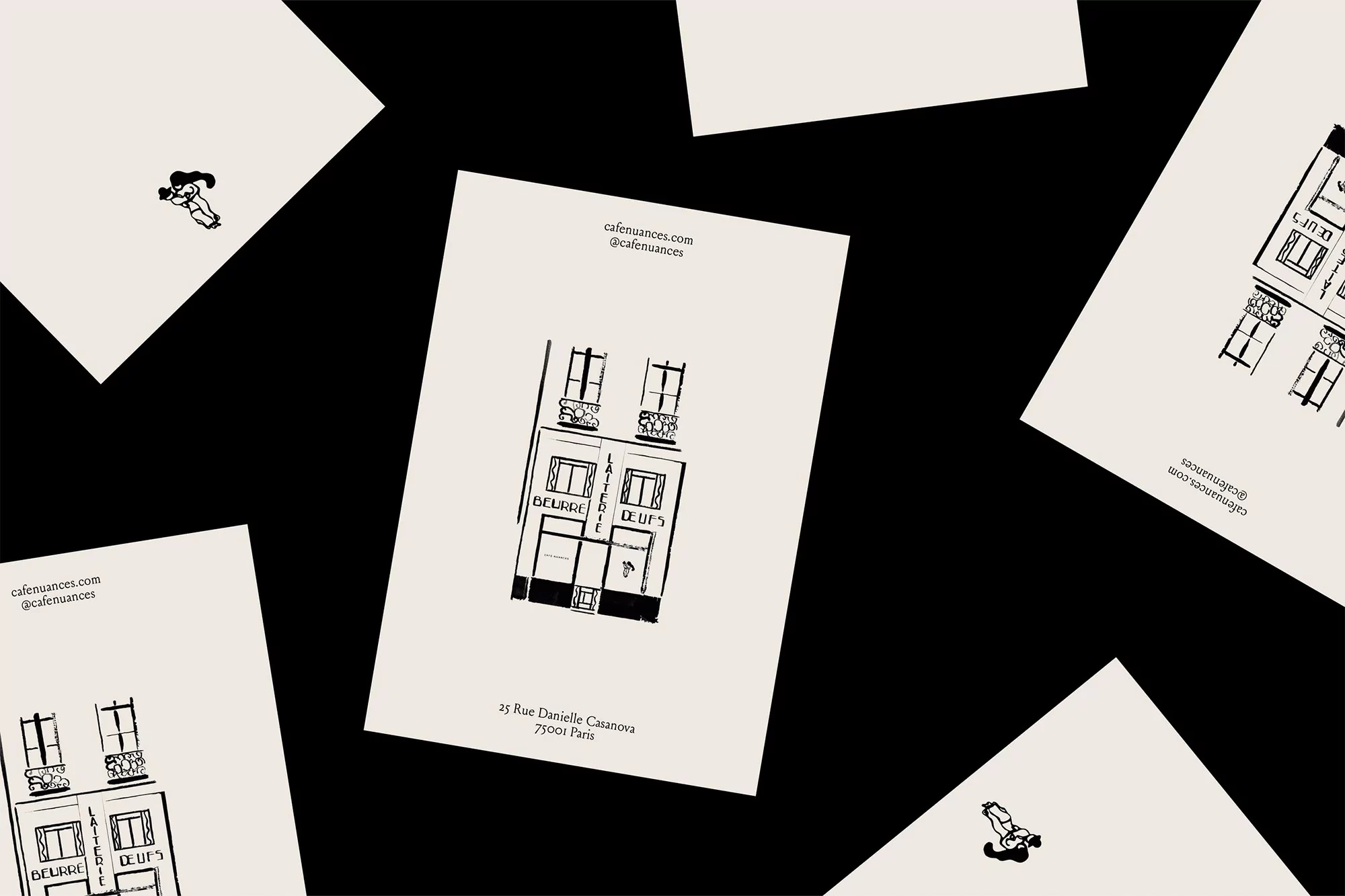 Illustration of a building facade on scattered cards against a black background, featuring cafe details and a small figure.