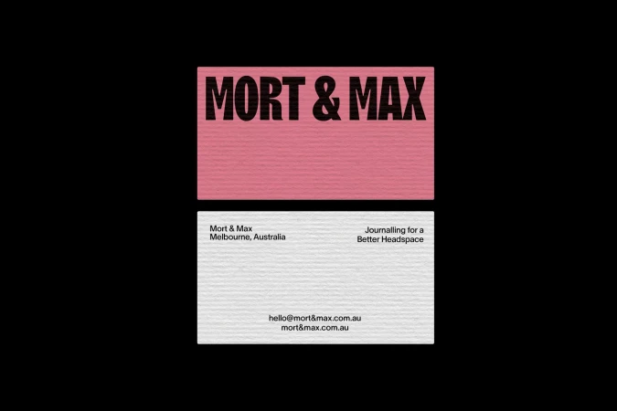 Promotional business card featuring a pink header with "Mort & Max" printed above their contact information and slogan.