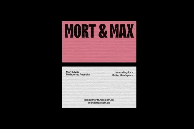 Two business cards for Mort & Max displayed against a solid black background, showing pink and white textured paper.
