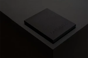 Black rectangular box featuring embossed One Delisle branding resting on a dark matte surface.