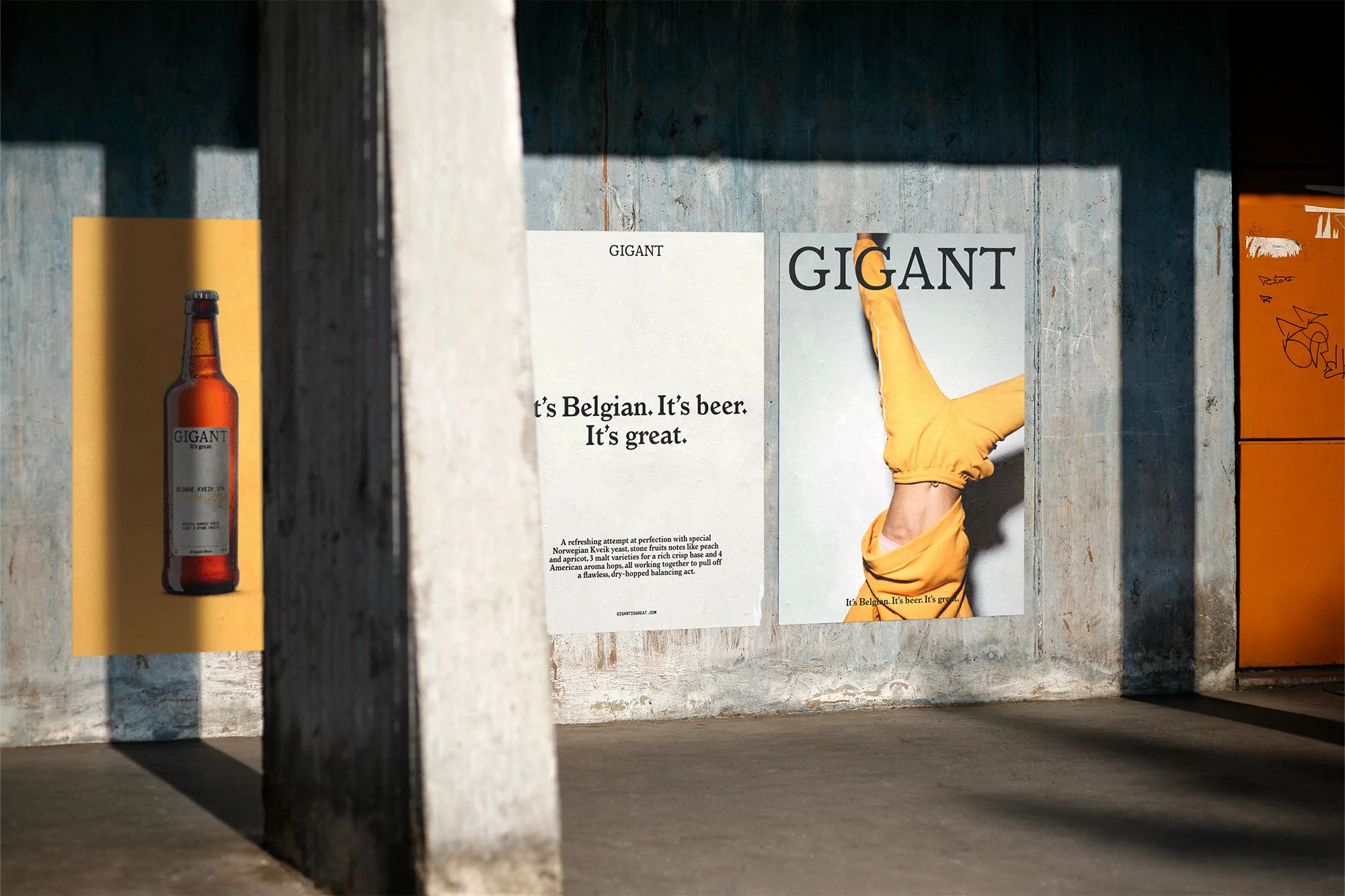 Outdoor advertising campaign featuring a beer bottle poster, alongside posters with text and a person in a yellow outfit on a textured wall.
