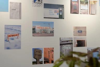 Collage of architectural and street photography prints displayed on a clean white wall by DNCO.