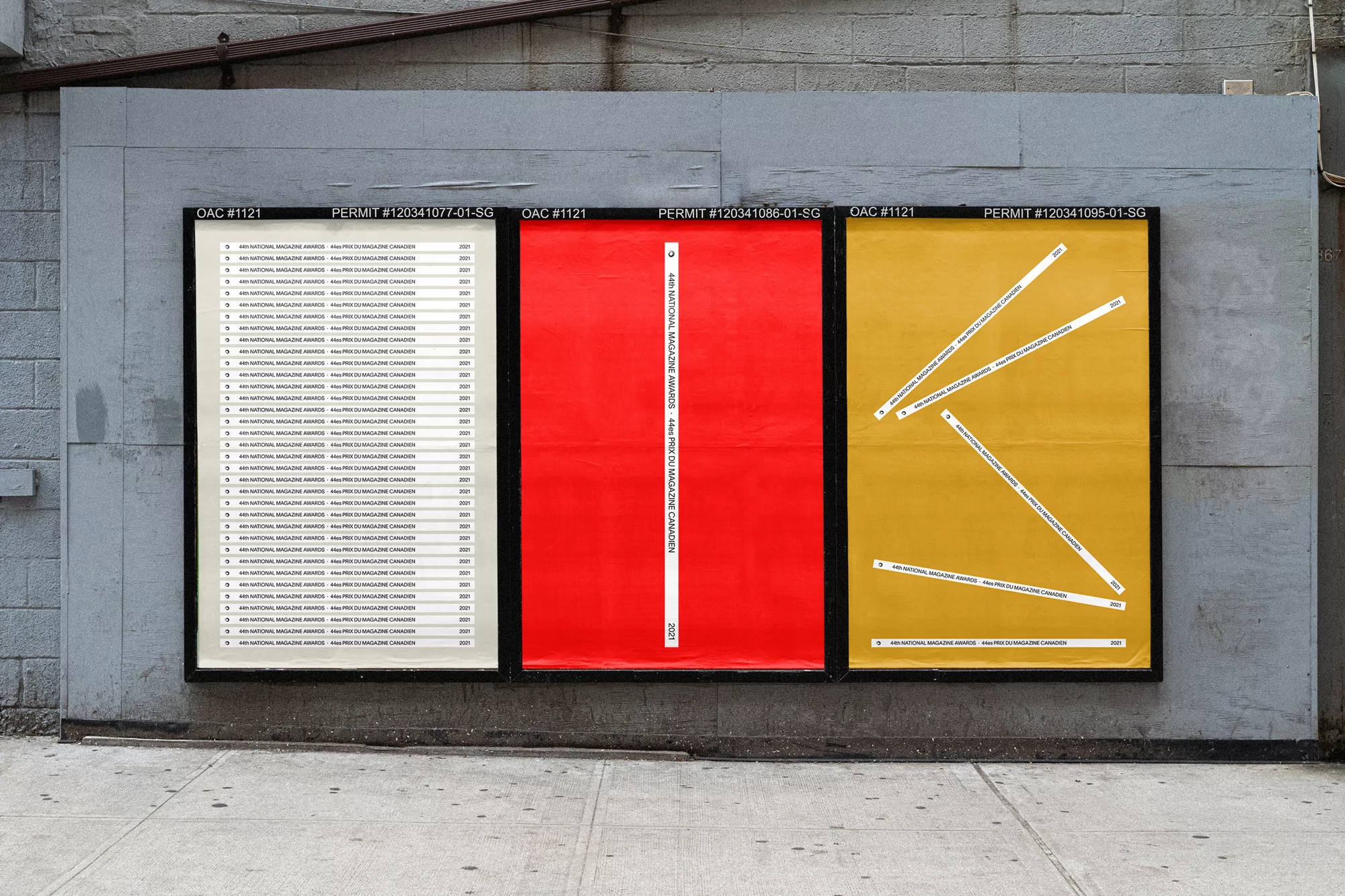 Outdoor shot of a billboard featuring three minimalist graphic design posters with red, yellow and off-white color palettes. Mounted on gray wall.