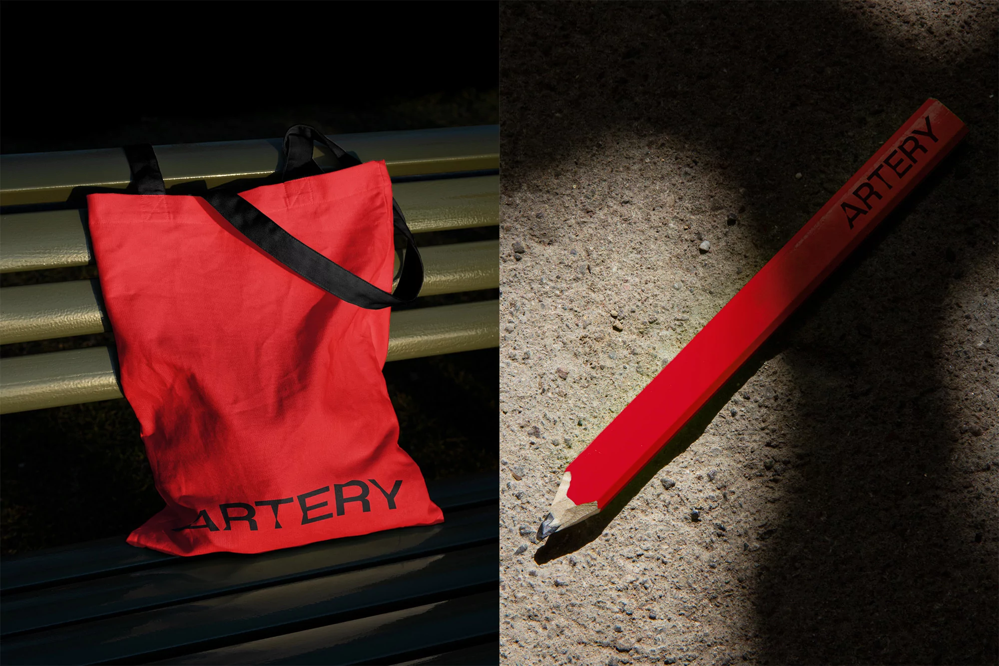 A bright red tote bag with black straps and the word 'ARTERY' on a bench, alongside a large red pencil with the same word.