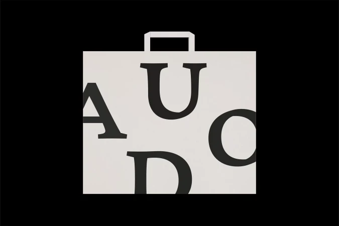 Modern black and white graphic art featuring a stylized shopping bag with large, bold letters on a solid black background.