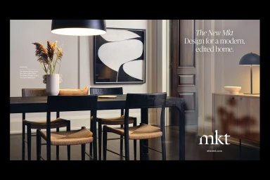 Modern dining room interior with a dark wooden table, woven chairs, a minimalist abstract artwork, and pendant lighting for Mkt.