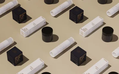 A flatlay arrangement of Brains Pure CBD product packaging including black jars, white boxes, and tubes on a beige surface.