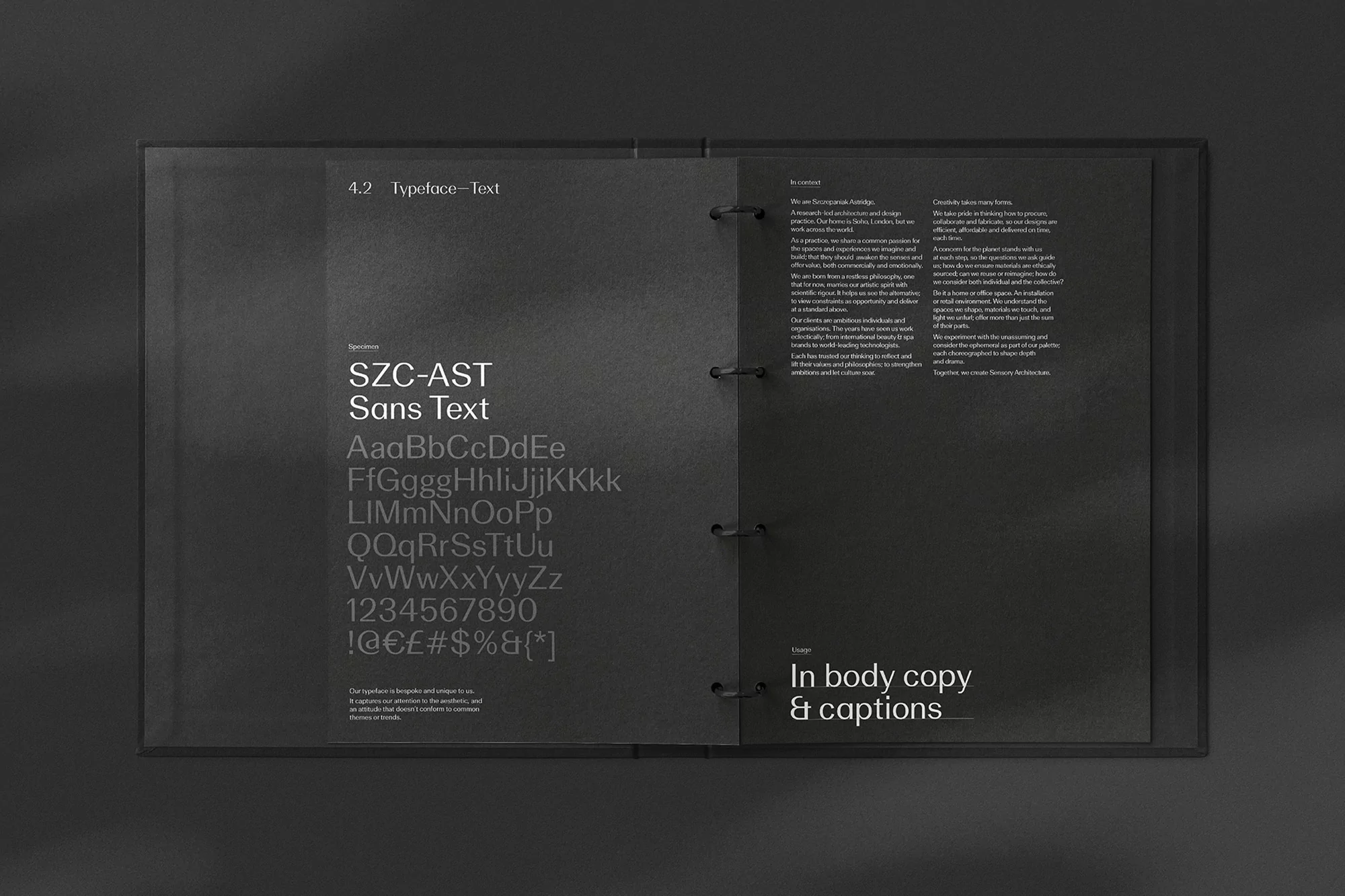 Open portfolio book displays a modern sans-serif typeface called SZC-AST Sans Text with upper and lowercase letters, numbers, and symbols.