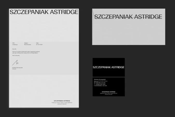 Brand identity mockup featuring letterhead, compliment slip, and business cards, presented on a grey background in a studio setting.