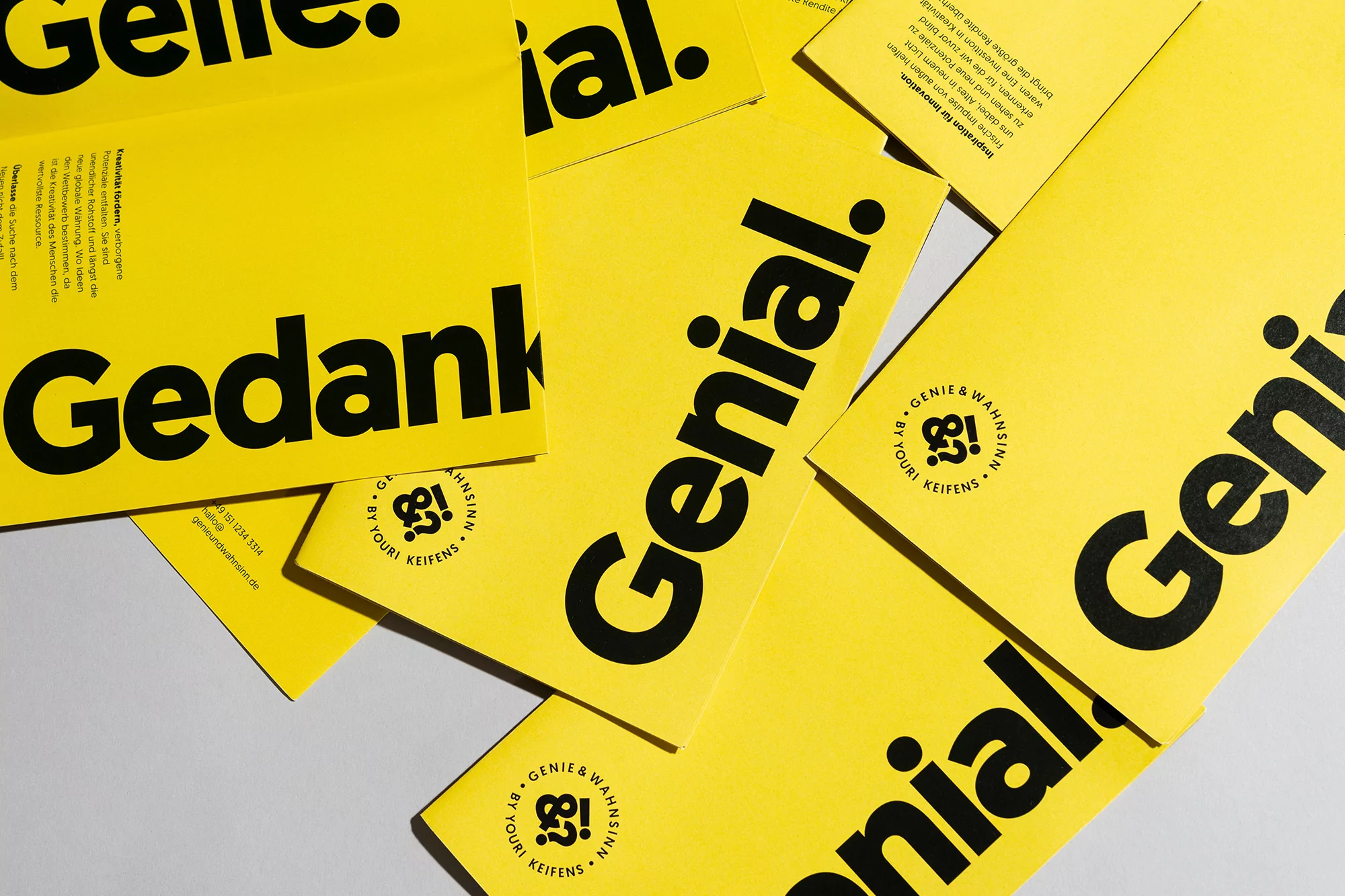 Graphic design featuring yellow cards with the word 'Genial' and 'Gedank' in bold black letters and the logo for Youri Keifens.