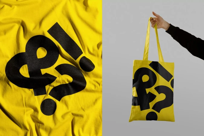 Yellow t-shirt and tote bag with black punctuation graphics. Fabric and bag display ampersand, question mark, and exclamation point symbols.