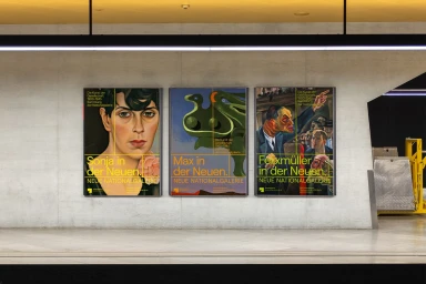 Three vertical art exhibition posters mounted on a light grey concrete wall featuring expressionist paintings and bold yellow typography.