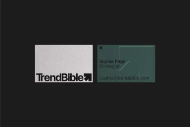 TrendBible brand identity design featuring a white textured card with logo and a dark green business card with debossed arrow graphic.