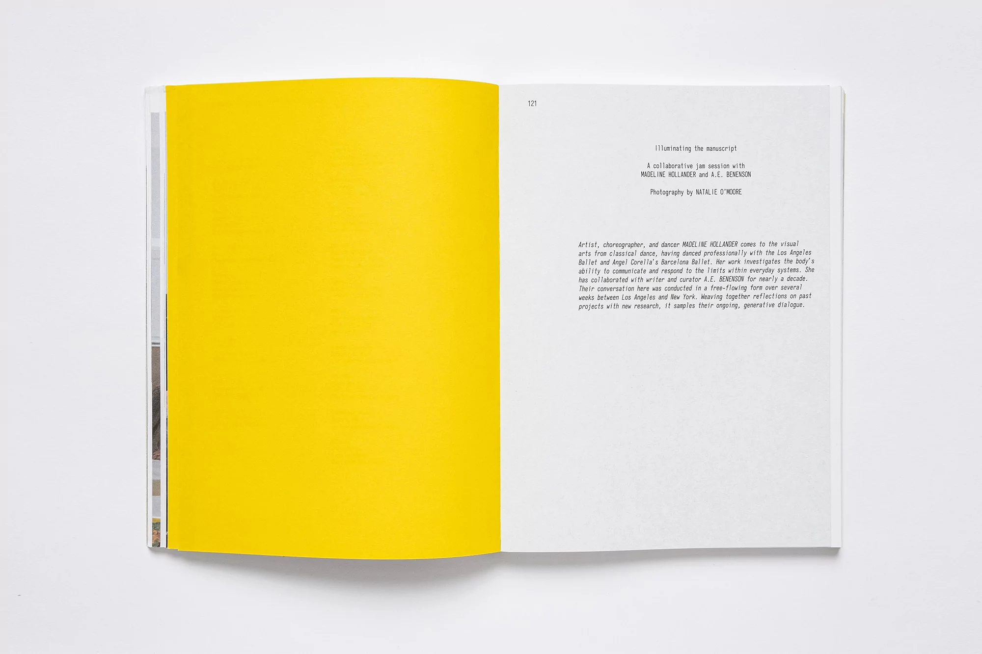 Open book with a bright yellow page on the left and text on the white page on the right. Studio shot, top down angle.