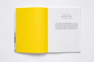 Open book spread featuring a solid yellow left page and a right text page with typography against a plain white background