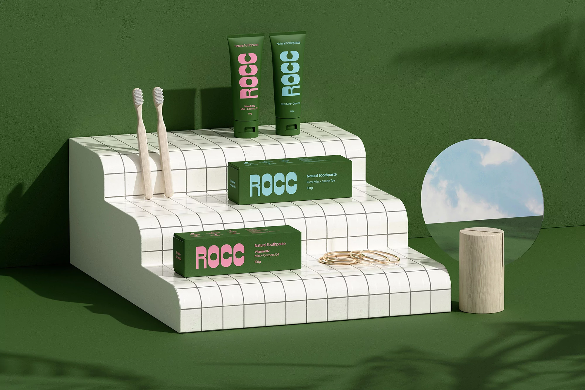 Product photography showcases green ROCC toothpaste tubes and boxes on a tiered white display with toothbrushes, against a green background.