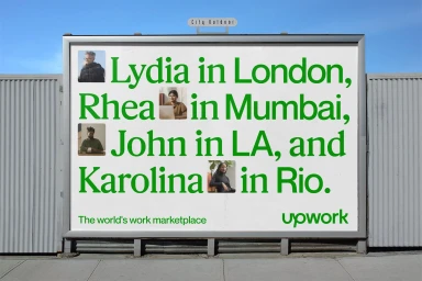 Outdoor billboard featuring Upwork brand identity design with green typography and portrait inserts against a clear sky