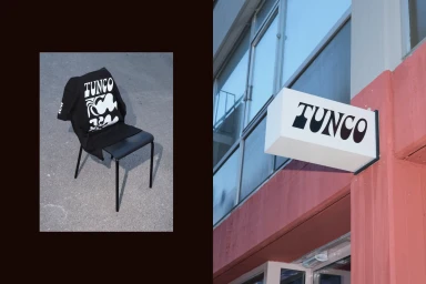 Black t shirt with white typography draped over a dark metal chair next to a Tunco store sign