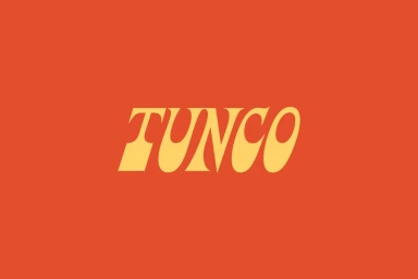 Bold yellow serif typography reading TUNCO centred on a flat solid orange background.