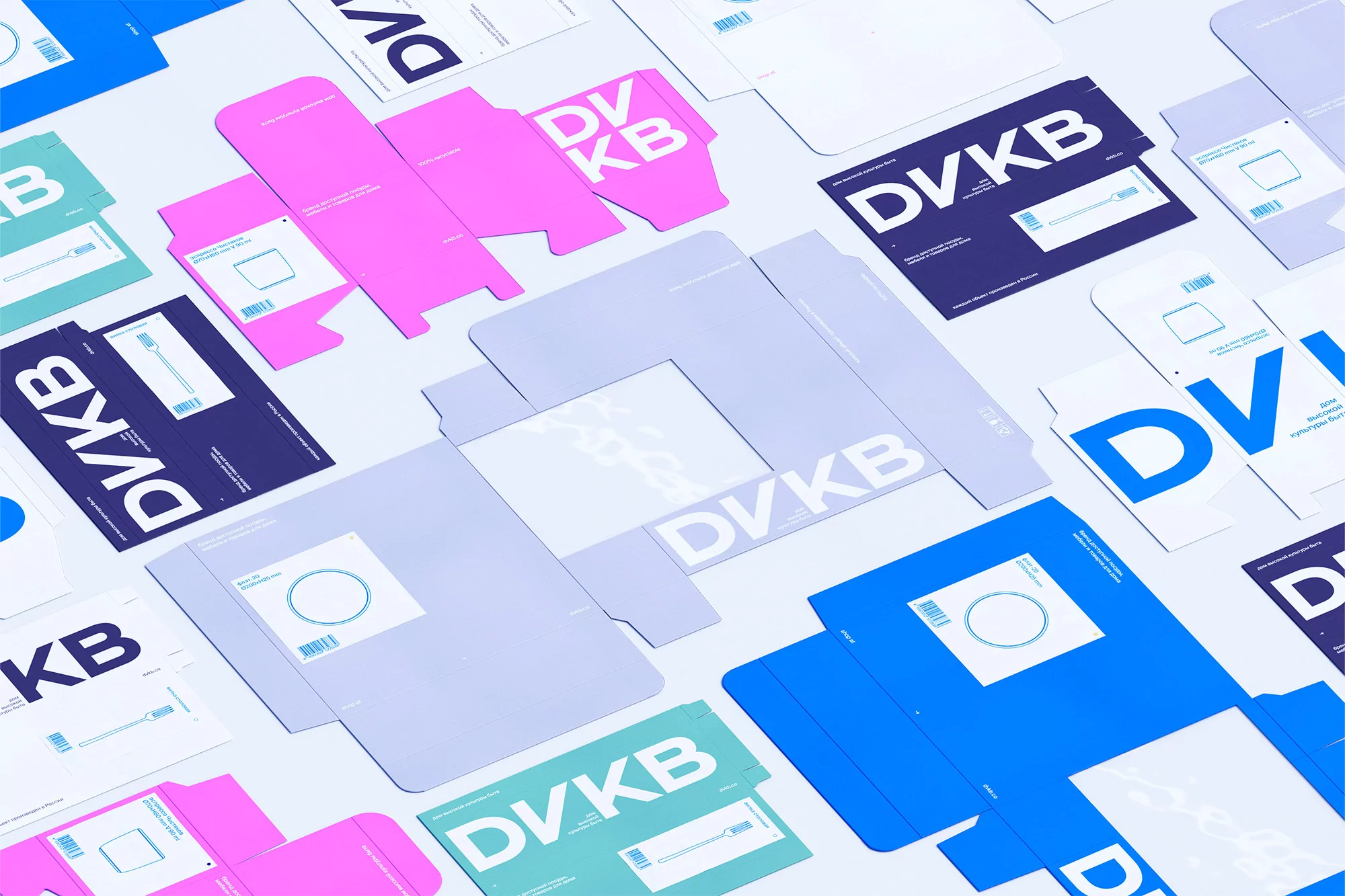 Flat lay of unfolded multicolored packaging templates with DVKV logo on white backdrop, graphic design for branding presentation.