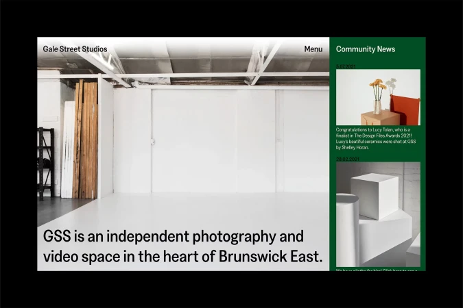 Bright photography studio with white walls, natural light, studio equipment and industrial ceiling. Independent photo and video space.