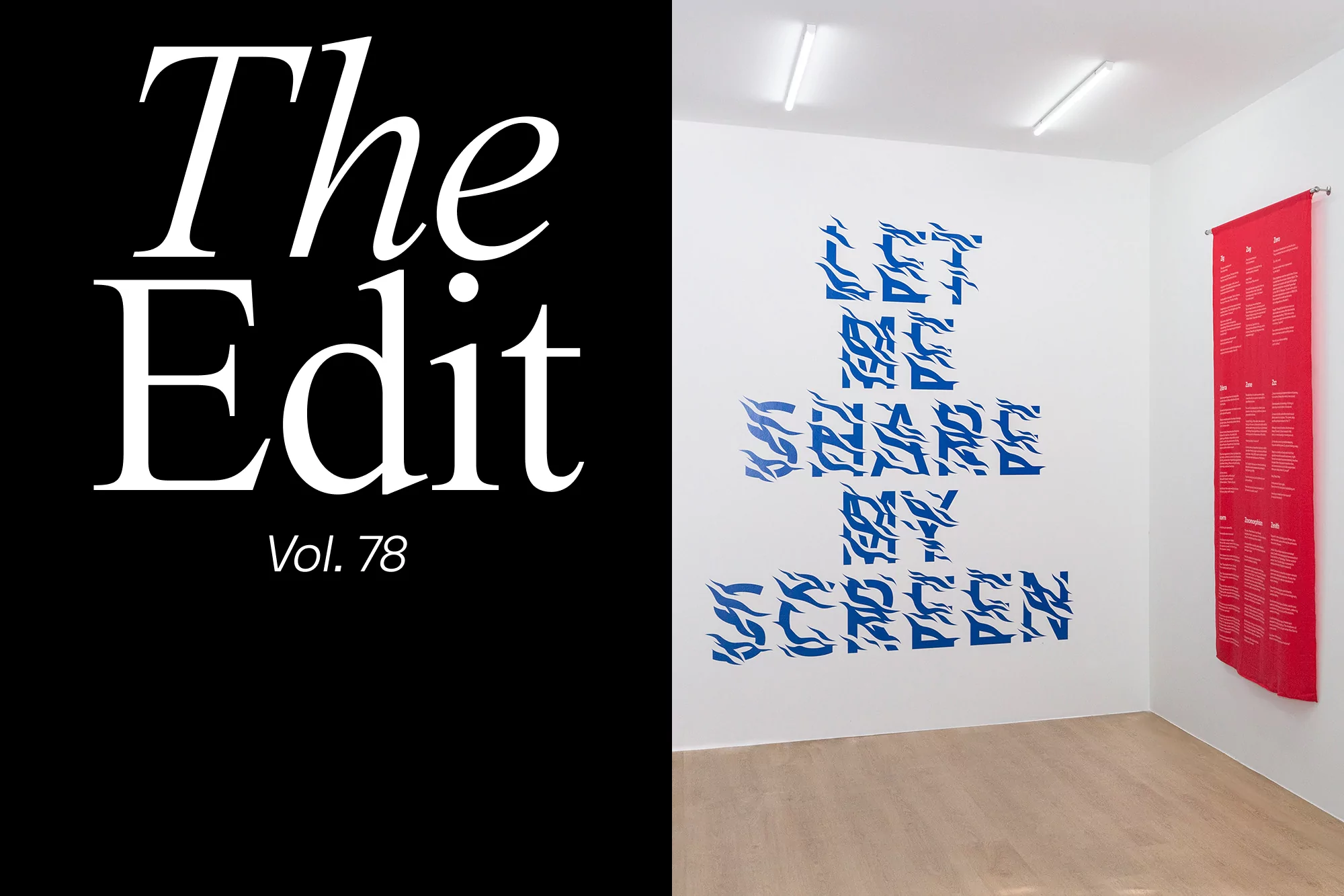 Interior of an art gallery featuring abstract blue text art on a white wall, a long red banner, and a monochrome magazine cover.
