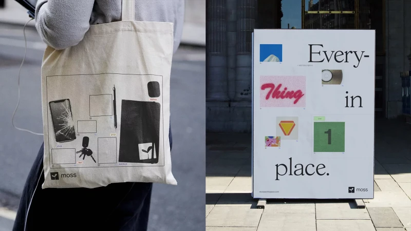 Person carrying a canvas tote bag with a print design of various objects, standing near a vertical advertisement board in an urban setting.