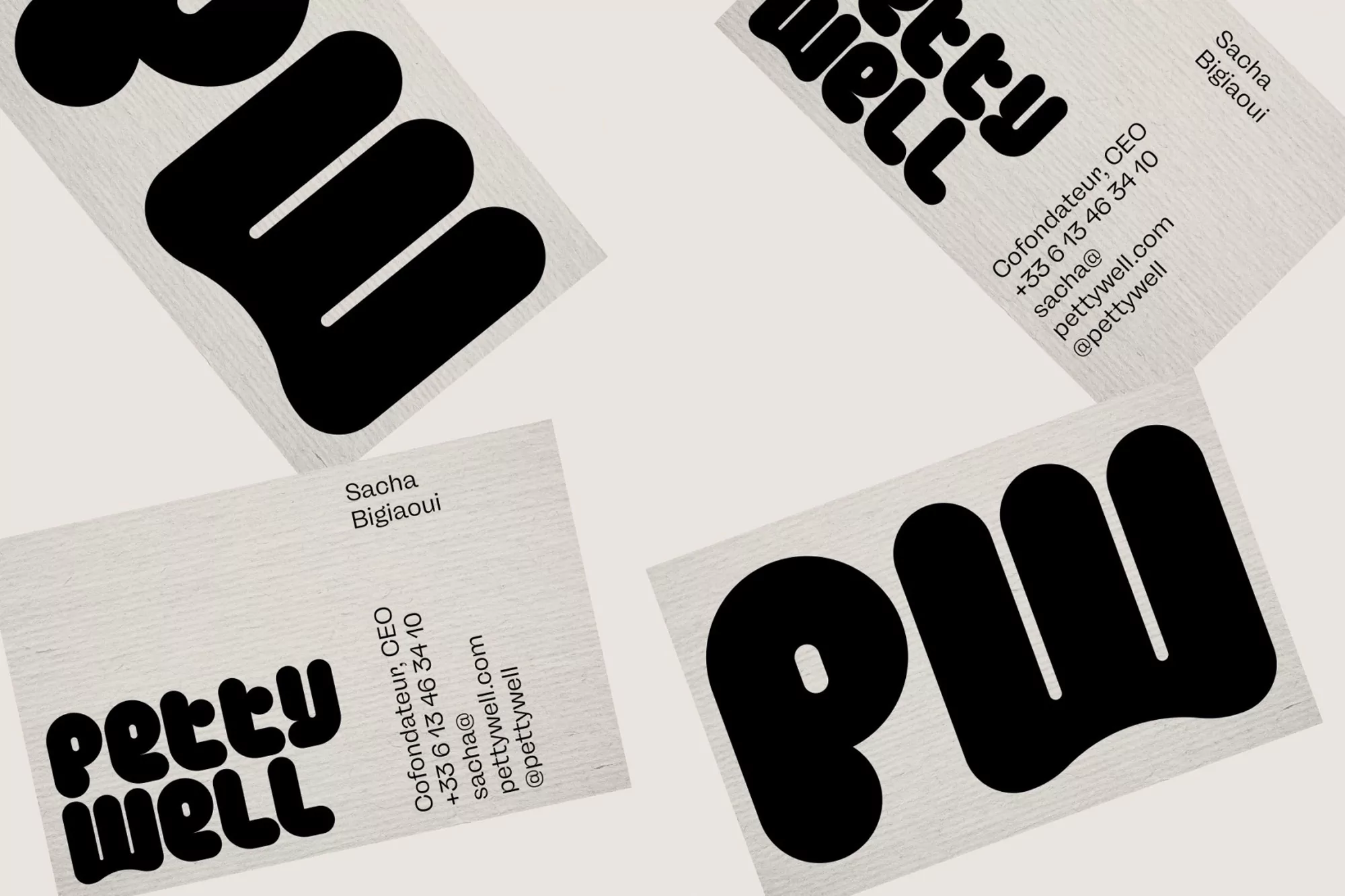 Minimalist business cards featuring the black, bold 'Petty Well' logo and contact information, set against a light, textured backdrop.