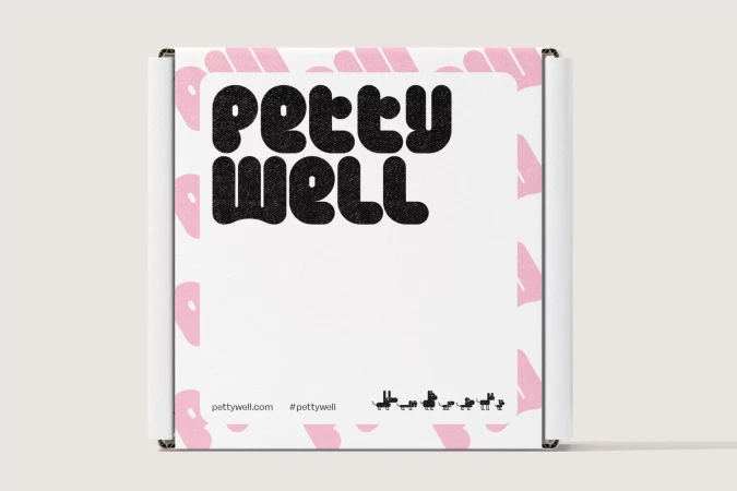 Cardboard box with a white label featuring the text "PETTY WELL" in bold black letters, plus a series of black dog silhouettes.