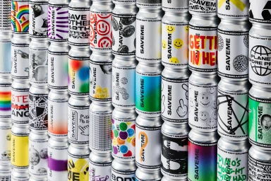 A stack of stacked aluminum beverage cans featuring diverse graphic designs and SAVEME branding.